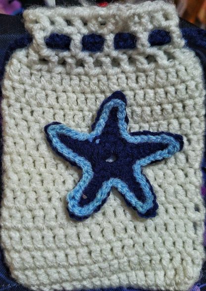 A handmade knitted pouch with the natural body mist inside.